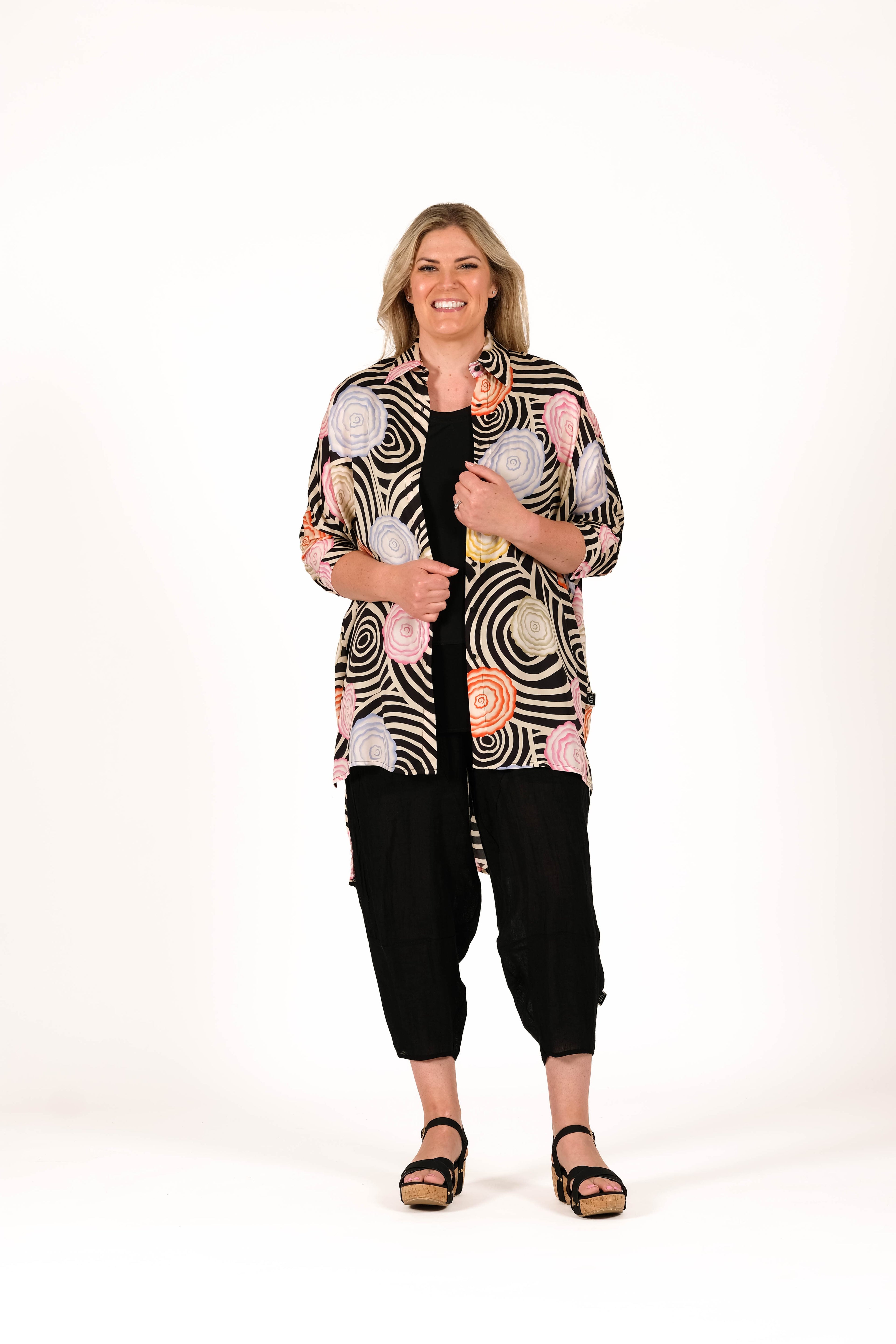 Relaxed, architectural, and effortlessly cool shirt. Featuring an oversized silhouette, soft collar detail, dropped sleeves, and a longer back hem for easy layering and movement. 