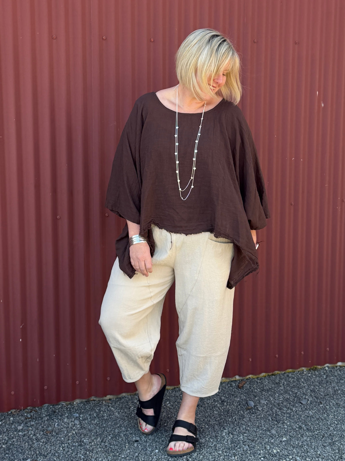 Cotton gauze tunic top. 100% breathable cotton, it's got an oversized fit, wide draped sleeves, and an asymmetrical frayed hem for that relaxed, lived-in vibe. Label: CINDY G