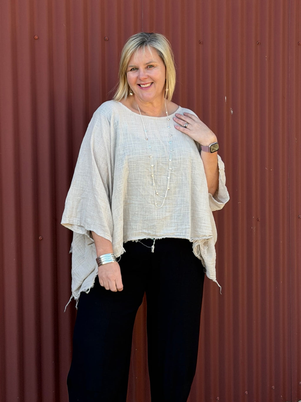 Cotton gauze tunic top. 100% breathable cotton, it's got an oversized fit, wide draped sleeves, and an asymmetrical frayed hem for that relaxed, lived-in vibe. Label: CINDY G
