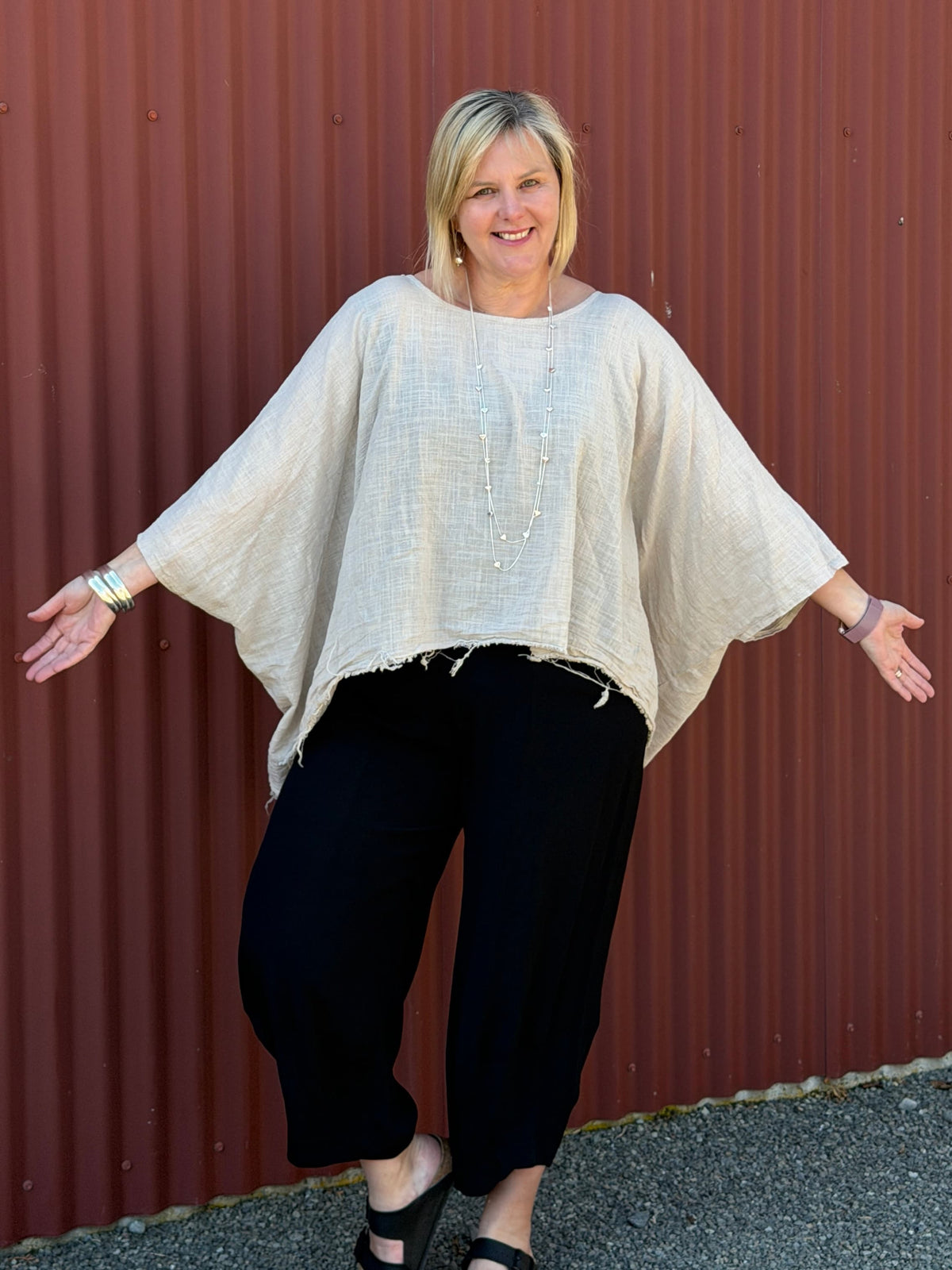 Cotton gauze tunic top. 100% breathable cotton, it's got an oversized fit, wide draped sleeves, and an asymmetrical frayed hem for that relaxed, lived-in vibe. Label: CINDY G