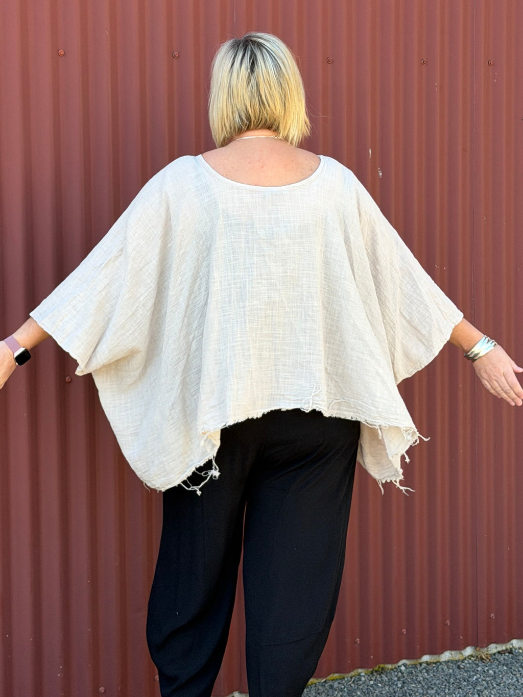 Cotton gauze tunic top. 100% breathable cotton, it's got an oversized fit, wide draped sleeves, and an asymmetrical frayed hem for that relaxed, lived-in vibe. Label: CINDY G