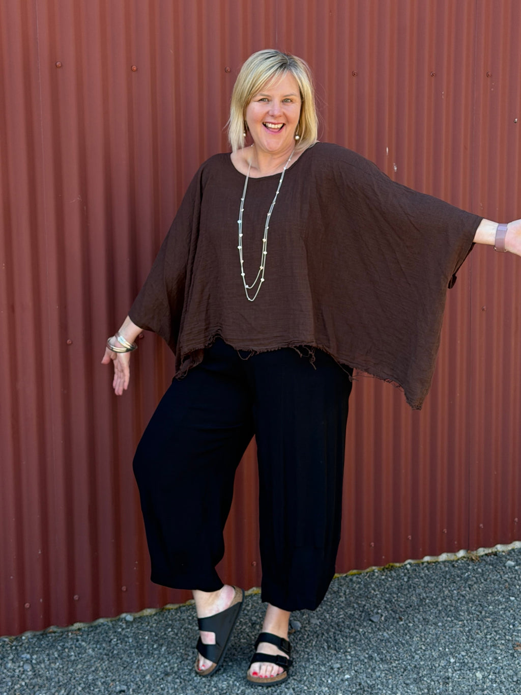 Cotton gauze tunic top. 100% breathable cotton, it's got an oversized fit, wide draped sleeves, and an asymmetrical frayed hem for that relaxed, lived-in vibe. Label: CINDY G
