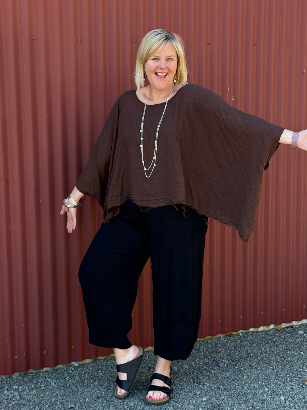 Cotton gauze tunic top. 100% breathable cotton, it's got an oversized fit, wide draped sleeves, and an asymmetrical frayed hem for that relaxed, lived-in vibe. Label: CINDY G