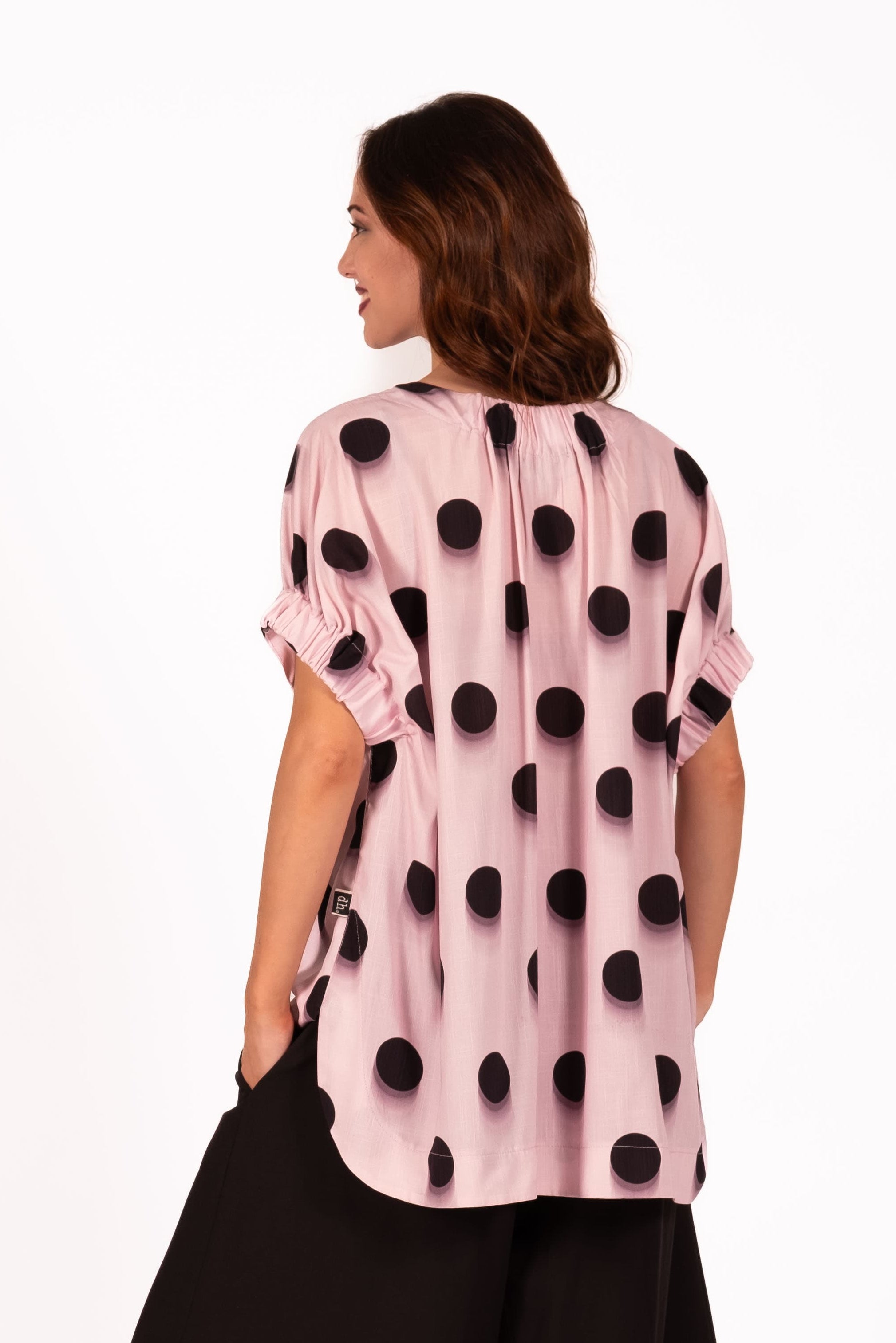Relaxed and contemporary with soft sculptural volume Top. Featuring wide draped shaping through the body, elasticated gathered arm detailing, and a softly curved hemline for effortless movement and edge. 