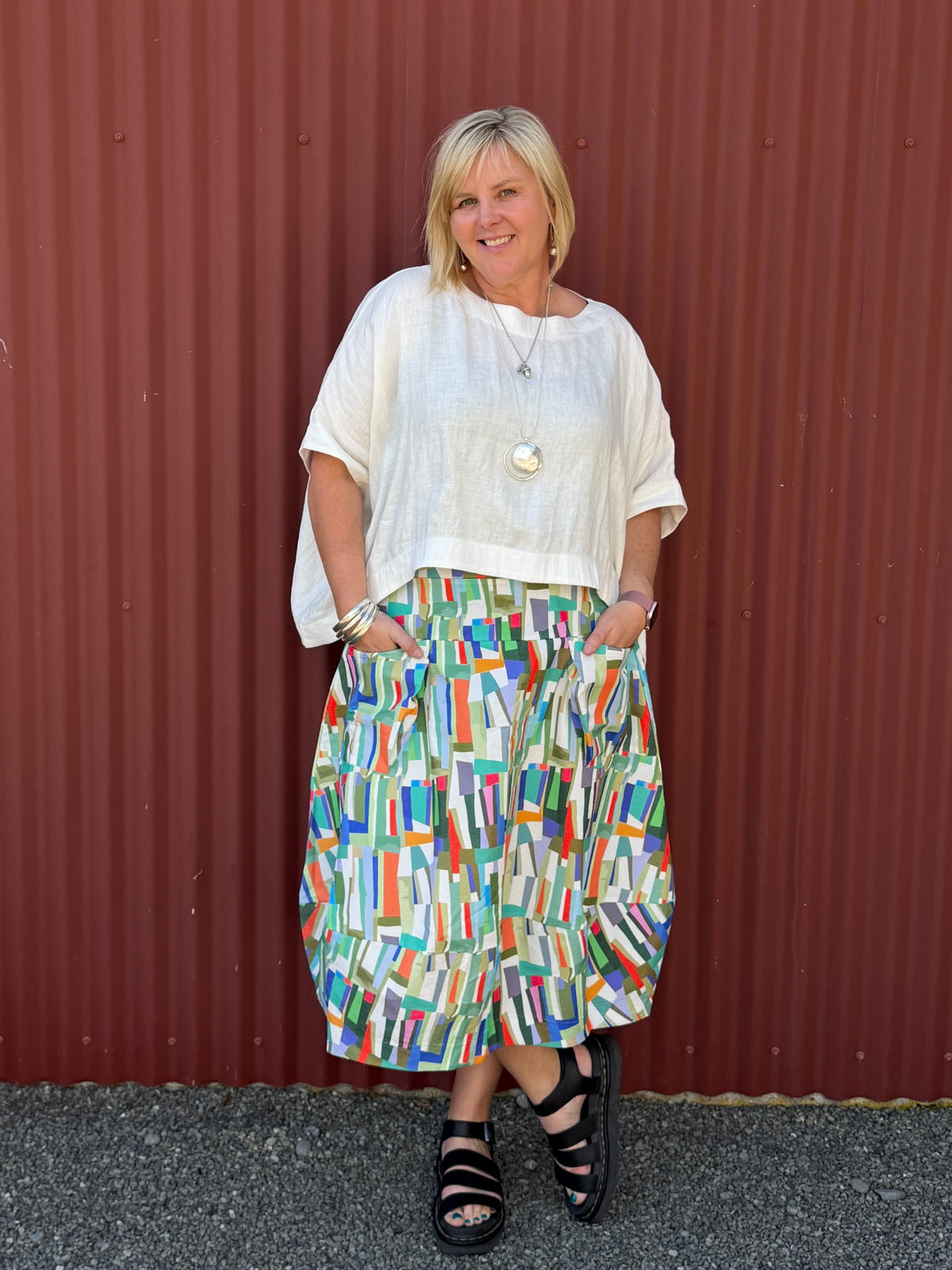 A gorgeous, easy-to-wear midi skirt featuring a vibrant abstract stripe print. Complete with an elasticated waistband, relaxed fit, and practical feature pockets.