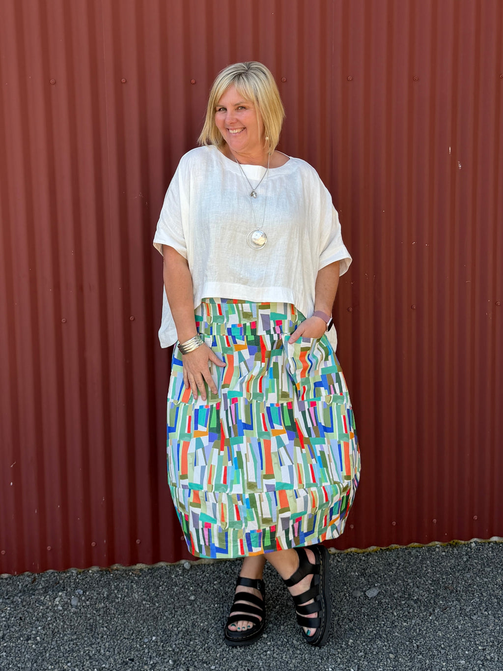 A gorgeous, easy-to-wear midi skirt featuring a vibrant abstract stripe print. Complete with an elasticated waistband, relaxed fit, and practical feature pockets.