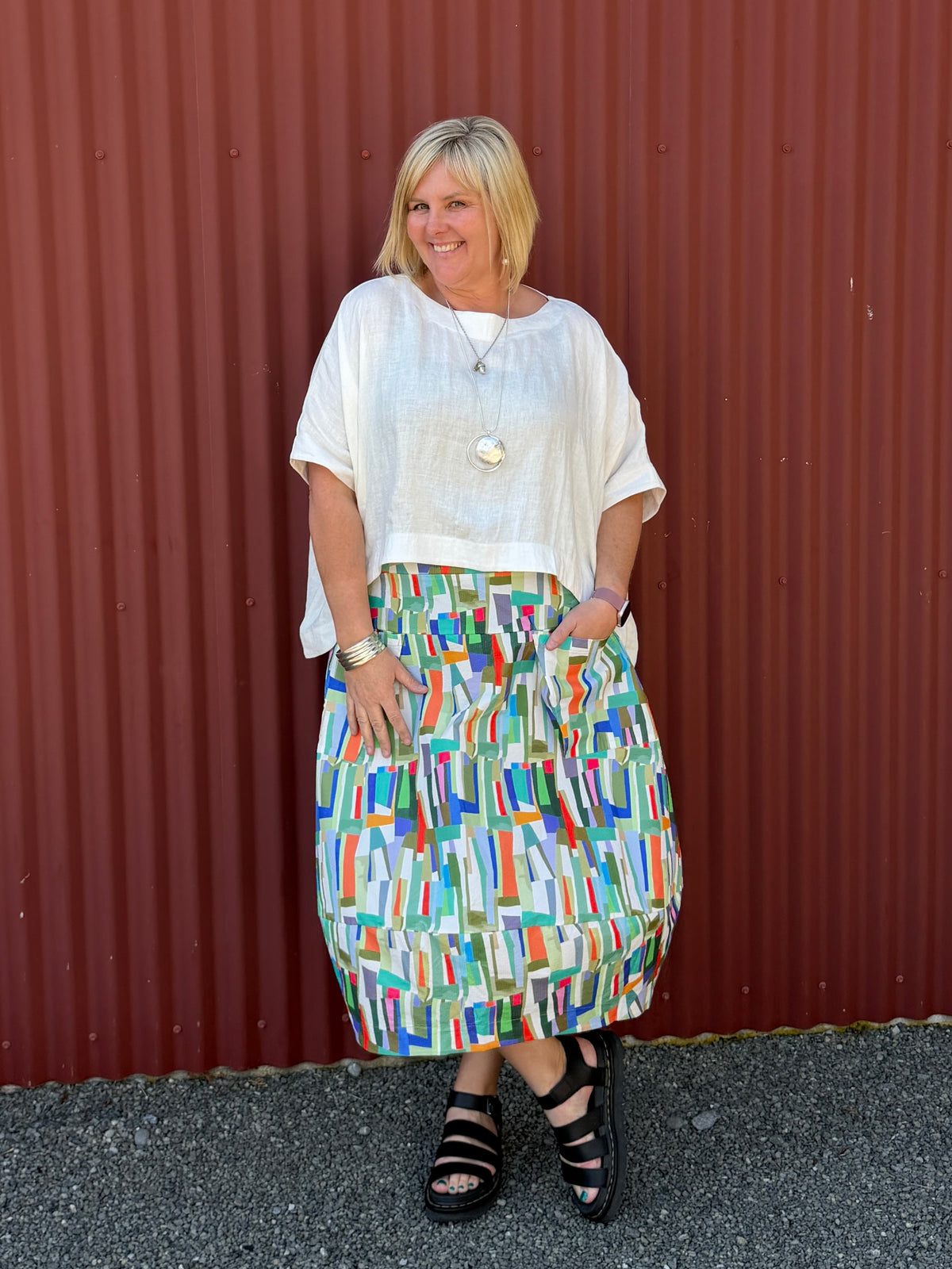 A gorgeous, easy-to-wear midi skirt featuring a vibrant abstract stripe print. Complete with an elasticated waistband, relaxed fit, and practical feature pockets.