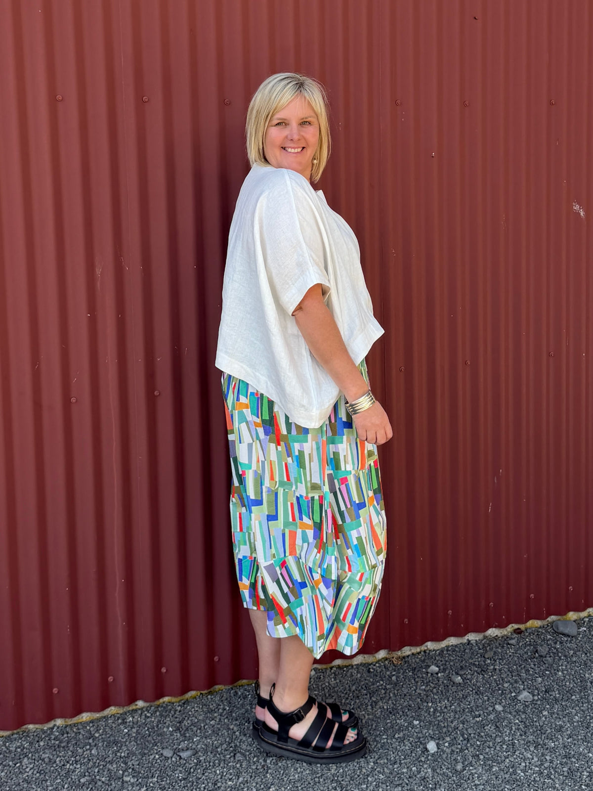 A gorgeous, easy-to-wear midi skirt featuring a vibrant abstract stripe print. Complete with an elasticated waistband, relaxed fit, and practical feature pockets.