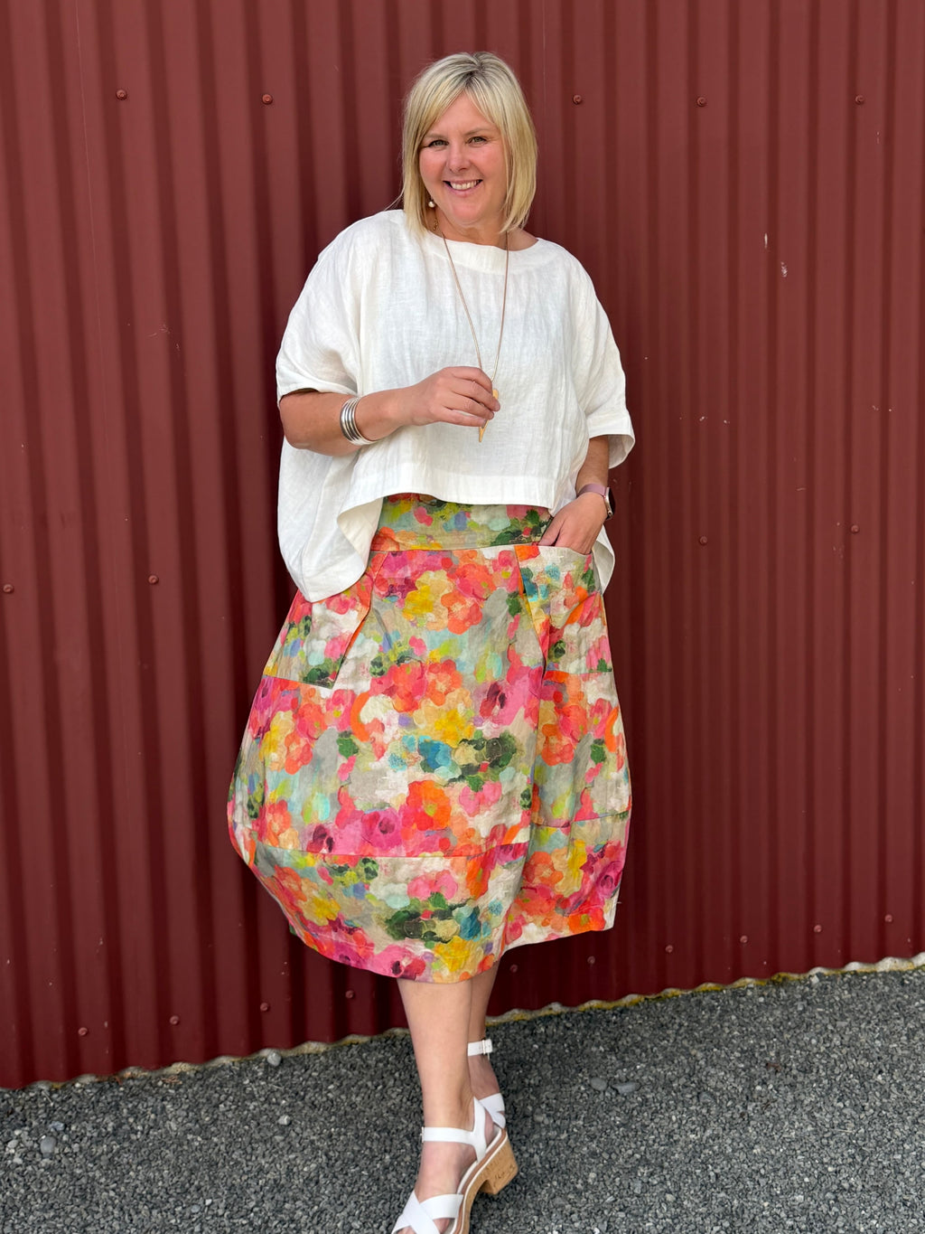 A gorgeous, easy-to-wear midi skirt featuring a Colourful Bloom print. Complete with an elasticated waistband, relaxed fit, and practical feature pockets. Crafted from 100% Wearing with the Cashews Celeste Cape Linen By LS Collection