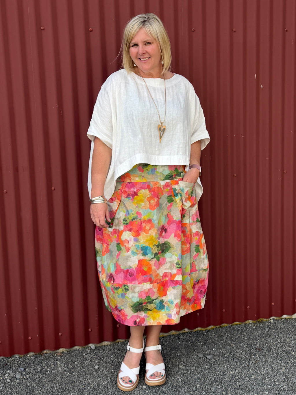 A gorgeous, easy-to-wear midi skirt featuring a Colourful Bloom print. Complete with an elasticated waistband, relaxed fit, and practical feature pockets. Crafted from 100% Wearing with the Cashews Celeste Cape Linen By LS Collection