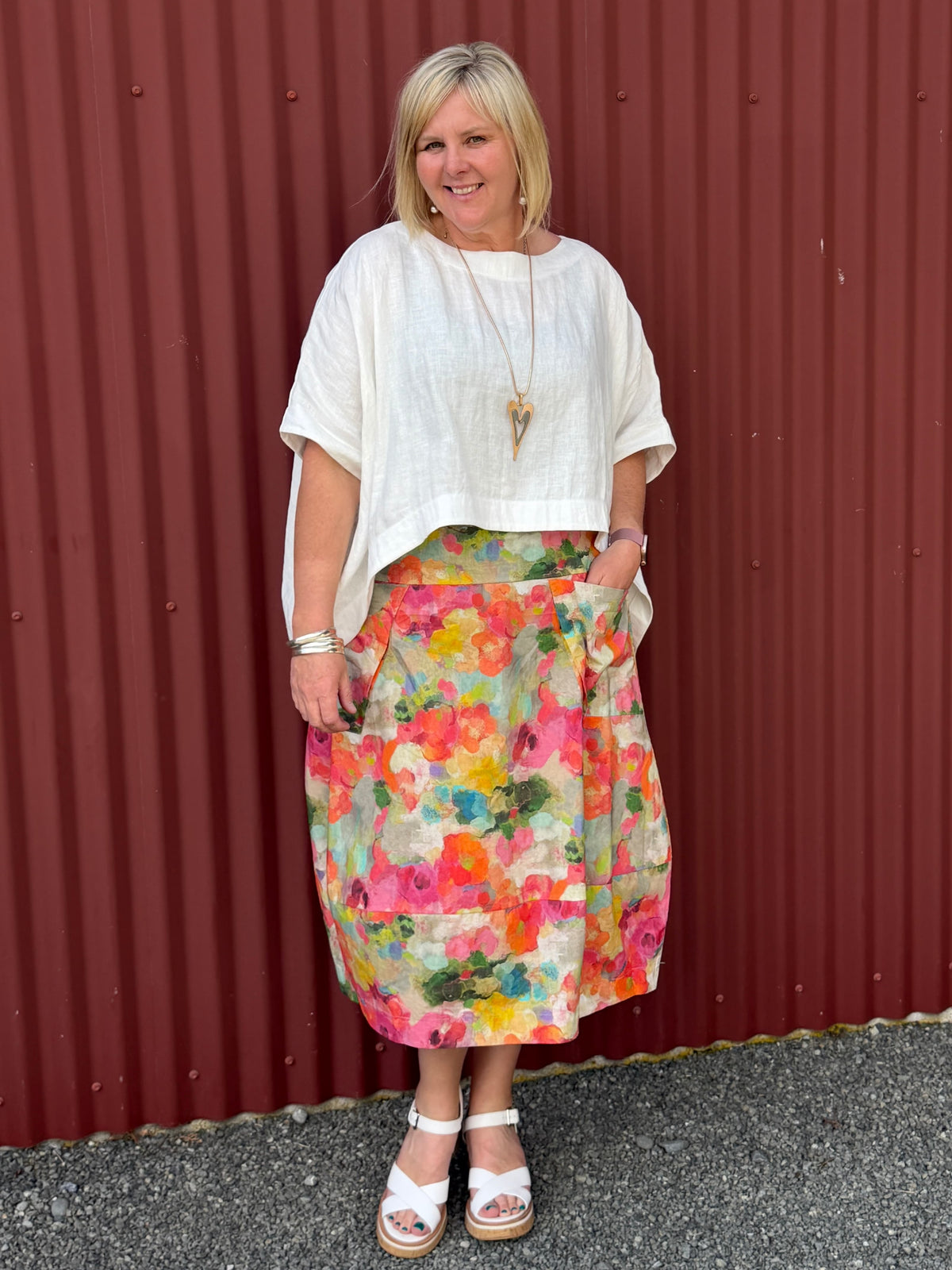 A gorgeous, easy-to-wear midi skirt featuring a Colourful Bloom print. Complete with an elasticated waistband, relaxed fit, and practical feature pockets. Crafted from 100% Wearing with the Cashews Celeste Cape Linen By LS Collection
