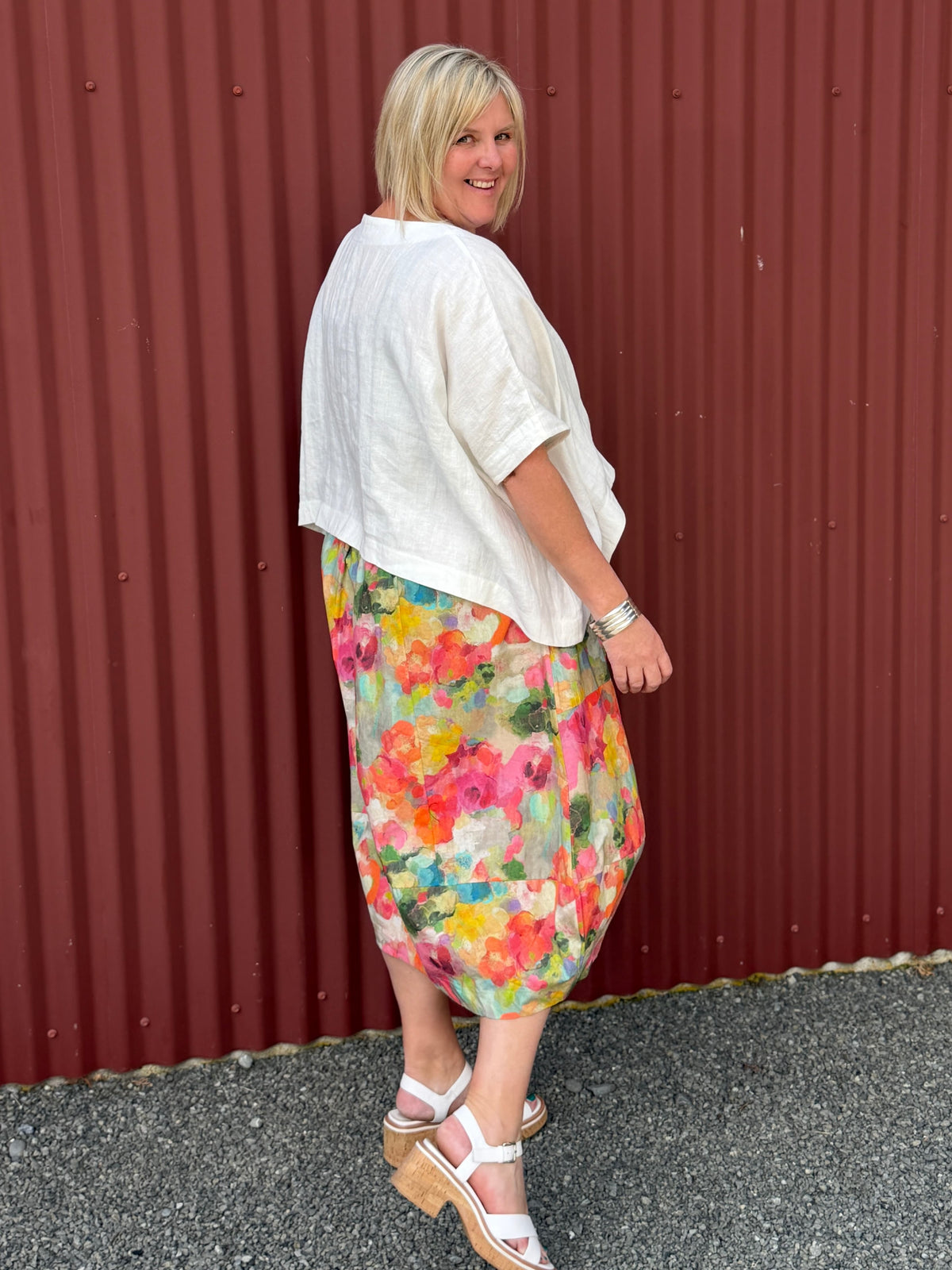 A gorgeous, easy-to-wear midi skirt featuring a Colourful Bloom print. Complete with an elasticated waistband, relaxed fit, and practical feature pockets. Crafted from 100% Wearing with the Cashews Celeste Cape Linen By LS Collection