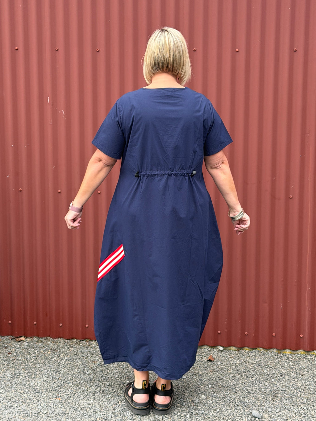 A crisp cotton look with a sporty modern edge, combining clean simplicity with relaxed everyday ease.

Relaxed and sculptural with soft shaping through the body. Featuring angled seam detailing, inset pockets, and subtle cocoon shaping that creates beautiful movement when worn. Finished with soft back elastic adjustable detailing for gentle shape and an effortless everyday feel with edge.
Designed in New Zealand for real women.

Fabric- Cotton