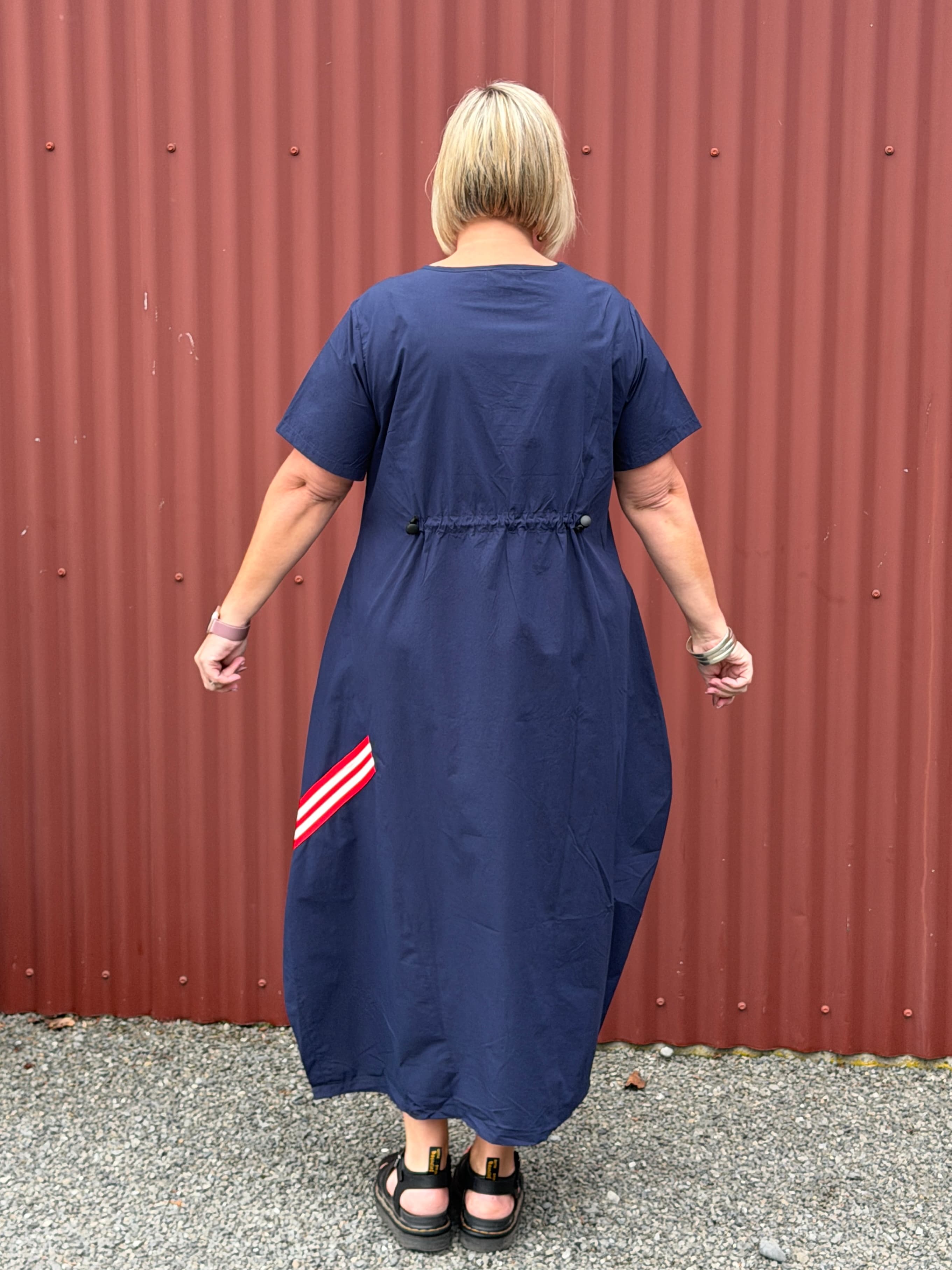 A crisp cotton look with a sporty modern edge, combining clean simplicity with relaxed everyday ease.

Relaxed and sculptural with soft shaping through the body. Featuring angled seam detailing, inset pockets, and subtle cocoon shaping that creates beautiful movement when worn. Finished with soft back elastic adjustable detailing for gentle shape and an effortless everyday feel with edge.
Designed in New Zealand for real women.

Fabric- Cotton