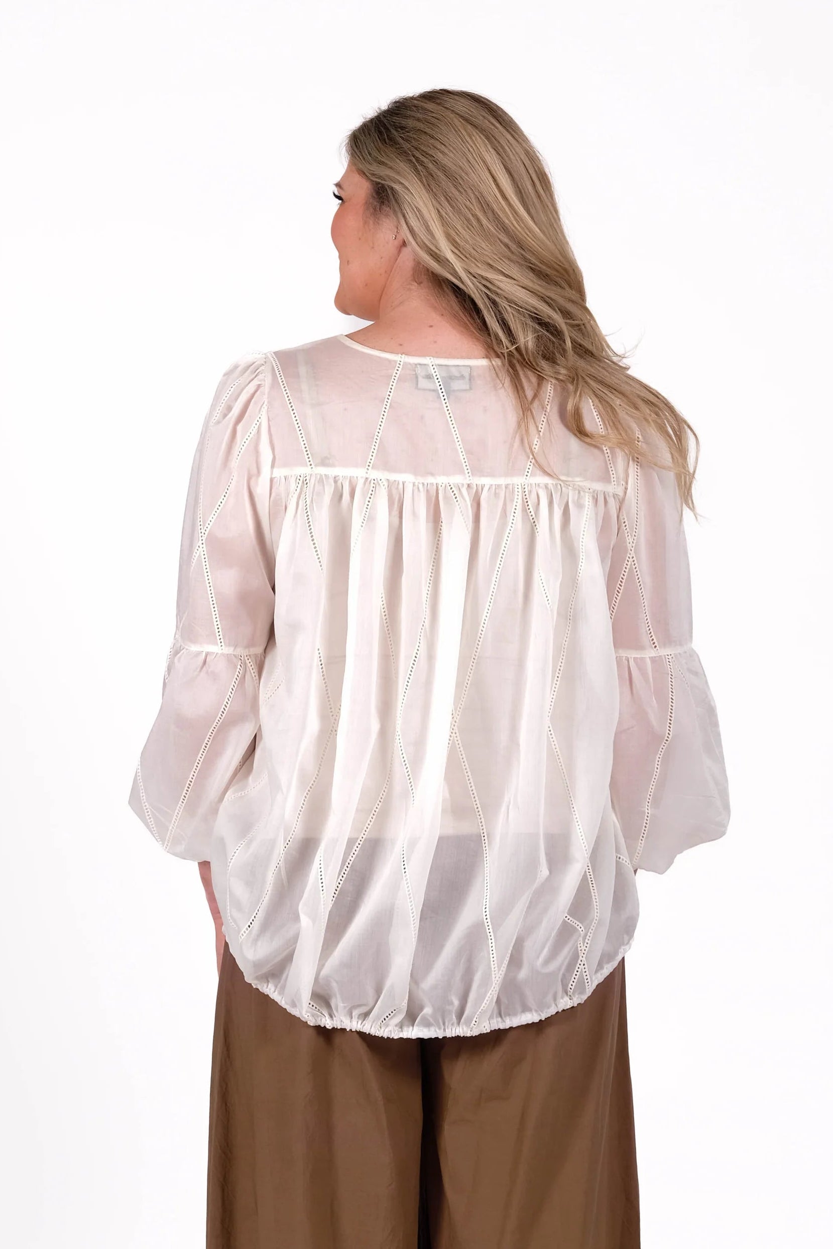A soft sheer ivory fabric with delicate stitched detailing, creating an elegant romantic look with effortless femininity. Softly structured with an effortless relaxed fit. 