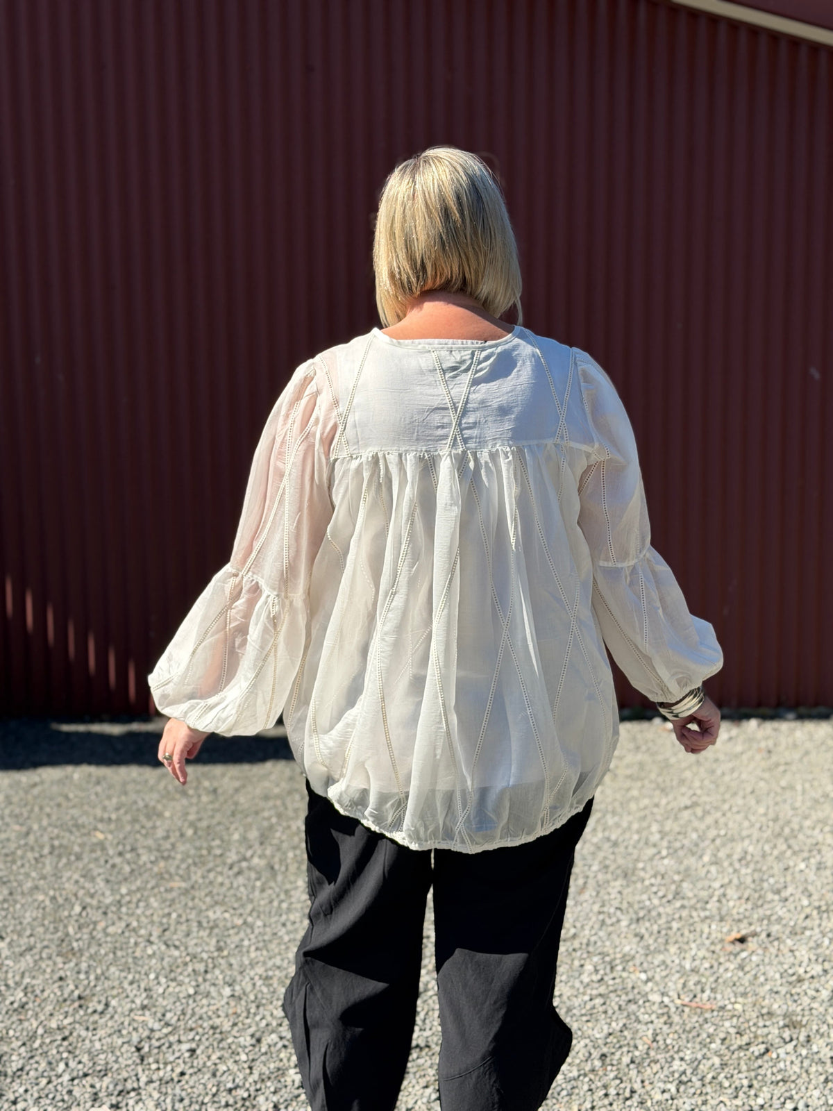 A soft sheer ivory fabric with delicate stitched detailing, creating an elegant romantic look with effortless femininity. Softly structured with an effortless relaxed fit. 