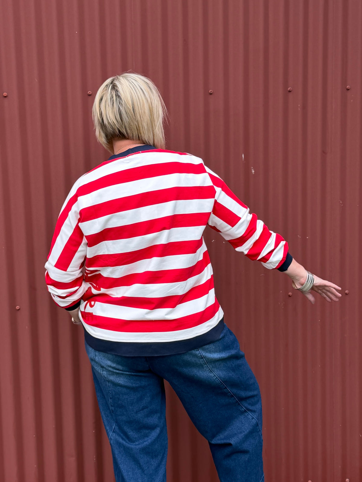 Classic with a sporty modern edge. This relaxed striped sweatshirt combines effortless everyday comfort with clean graphic lines and vibrant contrast detailing for an easy statement look. By Jellicoe