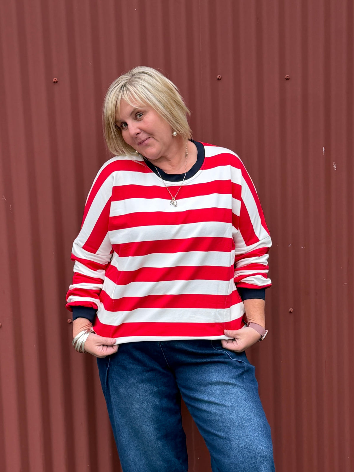 Classic with a sporty modern edge. This relaxed striped sweatshirt combines effortless everyday comfort with clean graphic lines and vibrant contrast detailing for an easy statement look. By Jellicoe