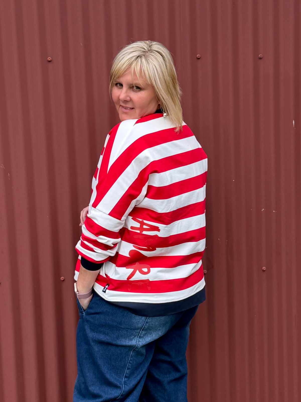 Classic with a sporty modern edge. This relaxed striped sweatshirt combines effortless everyday comfort with clean graphic lines and vibrant contrast detailing for an easy statement look. By Jellicoe