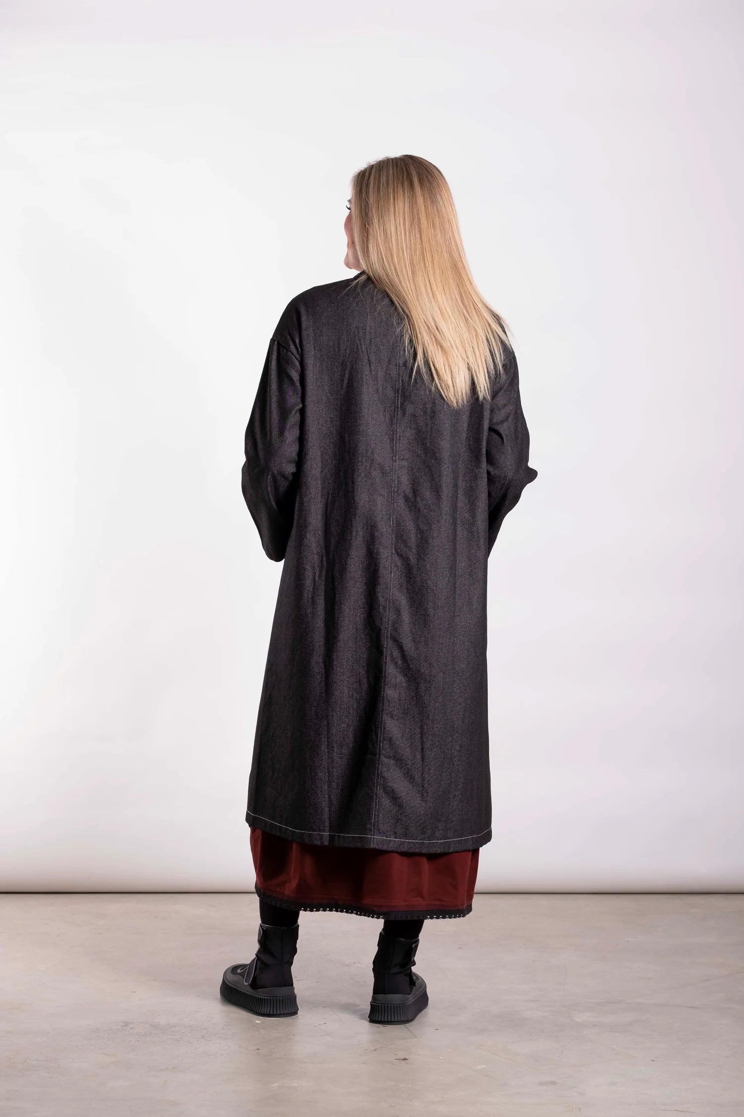 The Workshop Coat is Cut in black denim, this piece balances durability with modern tailoring. Designed in New Zealand for real women — strong, confident and made to be worn. By Deeanne Hobbs