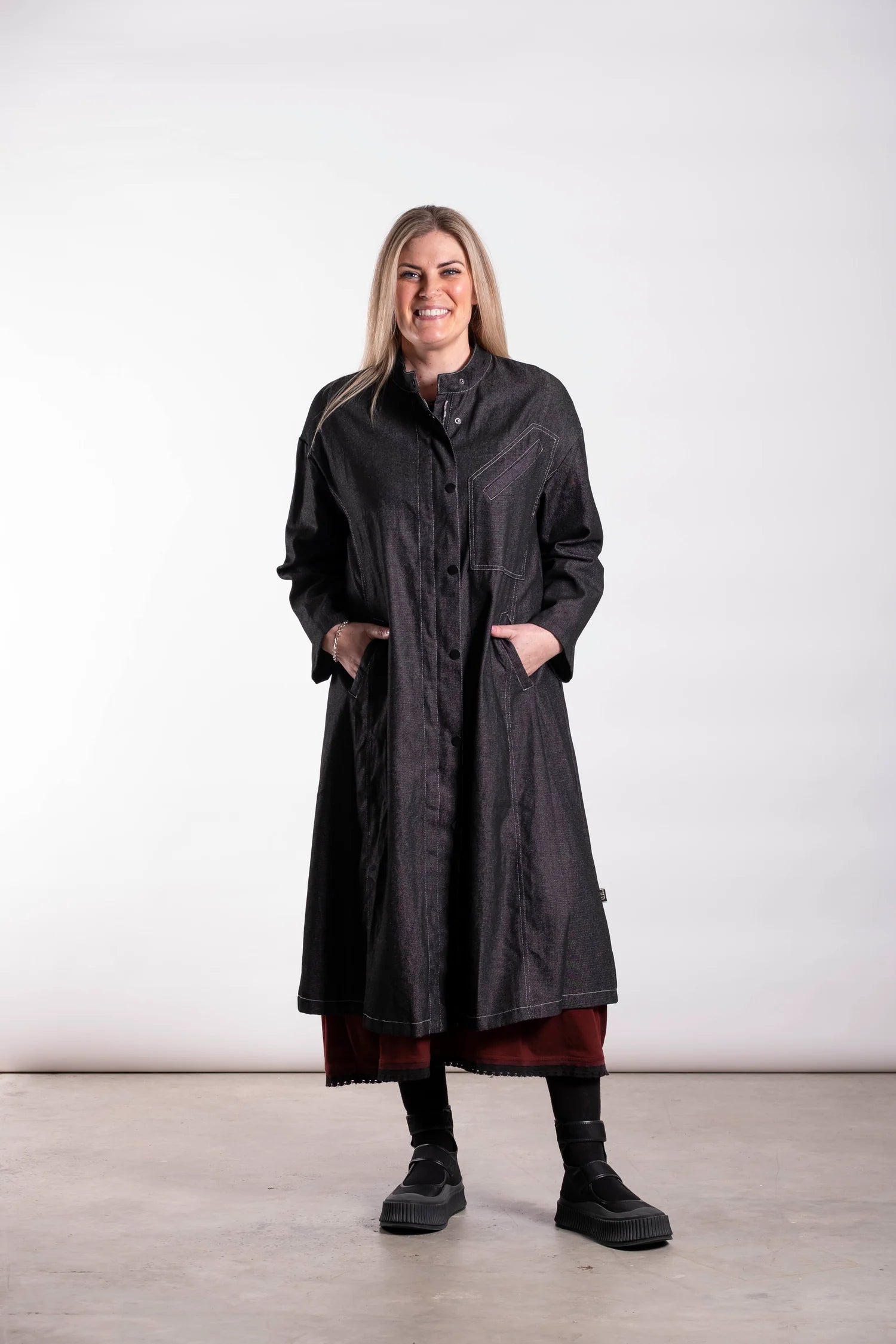 The Workshop Coat is Cut in black denim, this piece balances durability with modern tailoring. Designed in New Zealand for real women — strong, confident and made to be worn. By Deeanne Hobbs