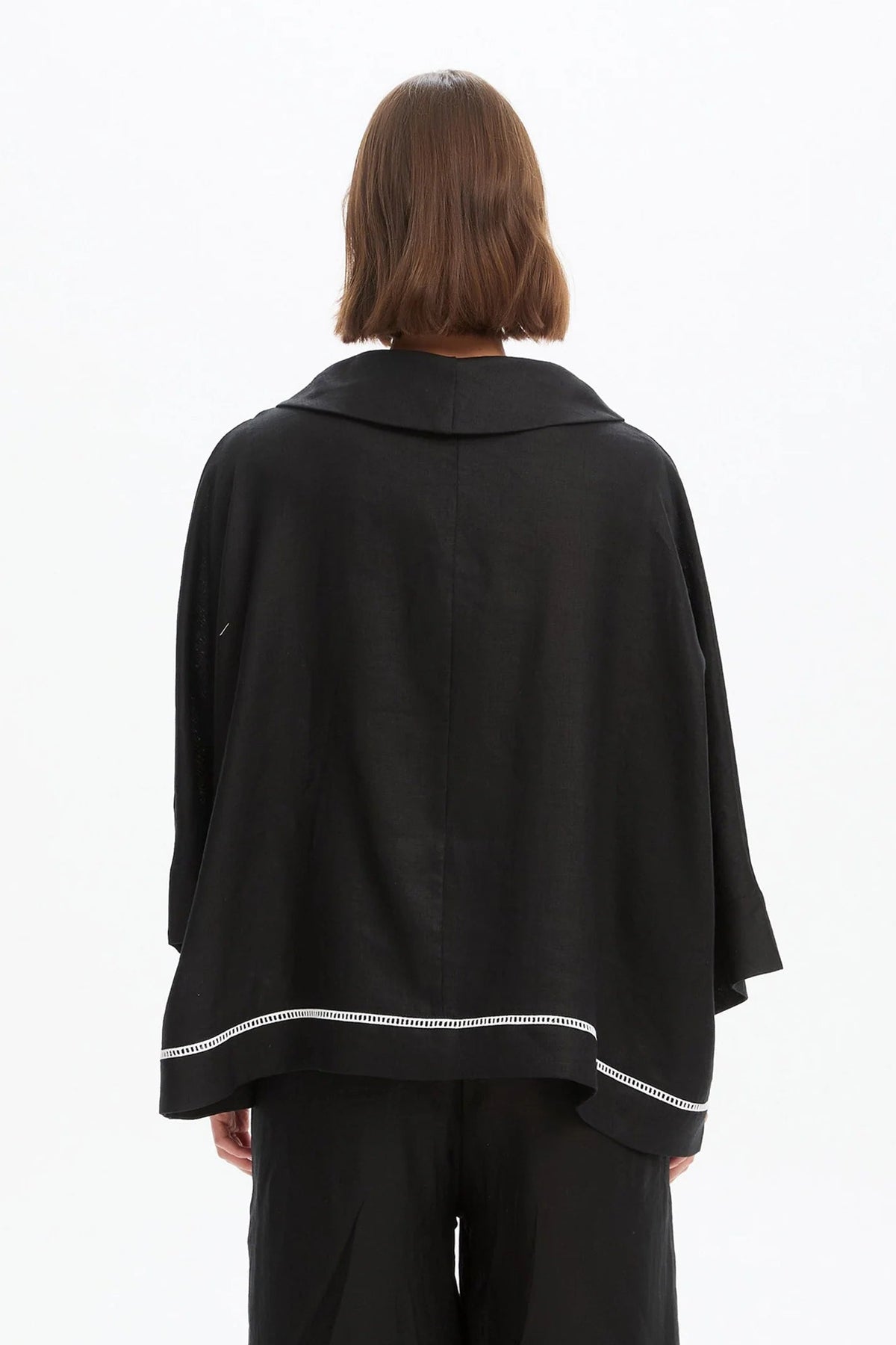 The Ladder Hem Cowl Neck Top brings a directional edge to everyday dressing with its considered, modern silhouette. Designed in a relaxed boxy fit, it features a soft cowl neckline and an asymmetric wrap front that creates subtle shape and movement. By Tirelli