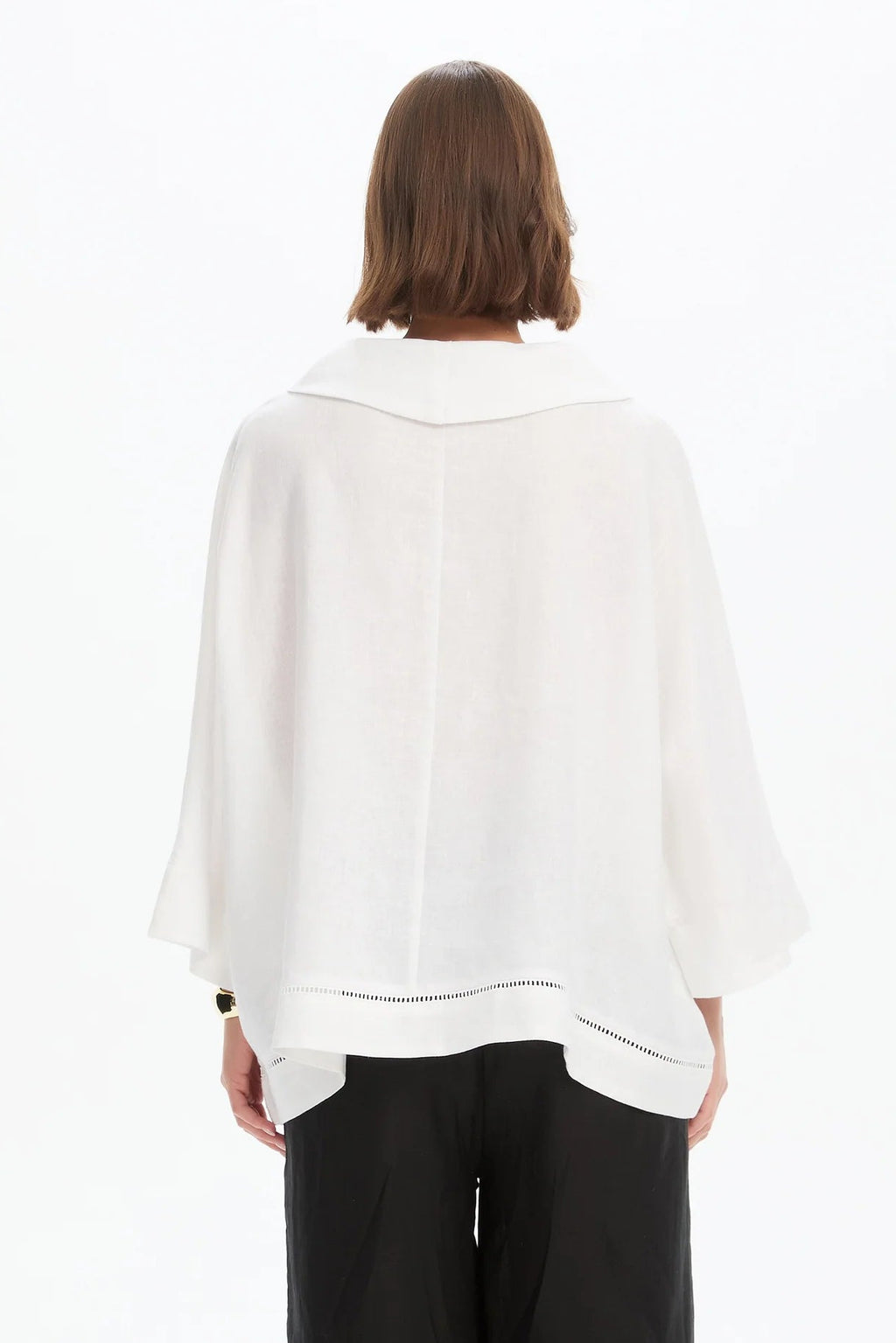 The Ladder Hem Cowl Neck Top brings a directional edge to everyday dressing with its considered, modern silhouette. Designed in a relaxed boxy fit, it features a soft cowl neckline and an asymmetric wrap front that creates subtle shape and movement.  By Tirelli