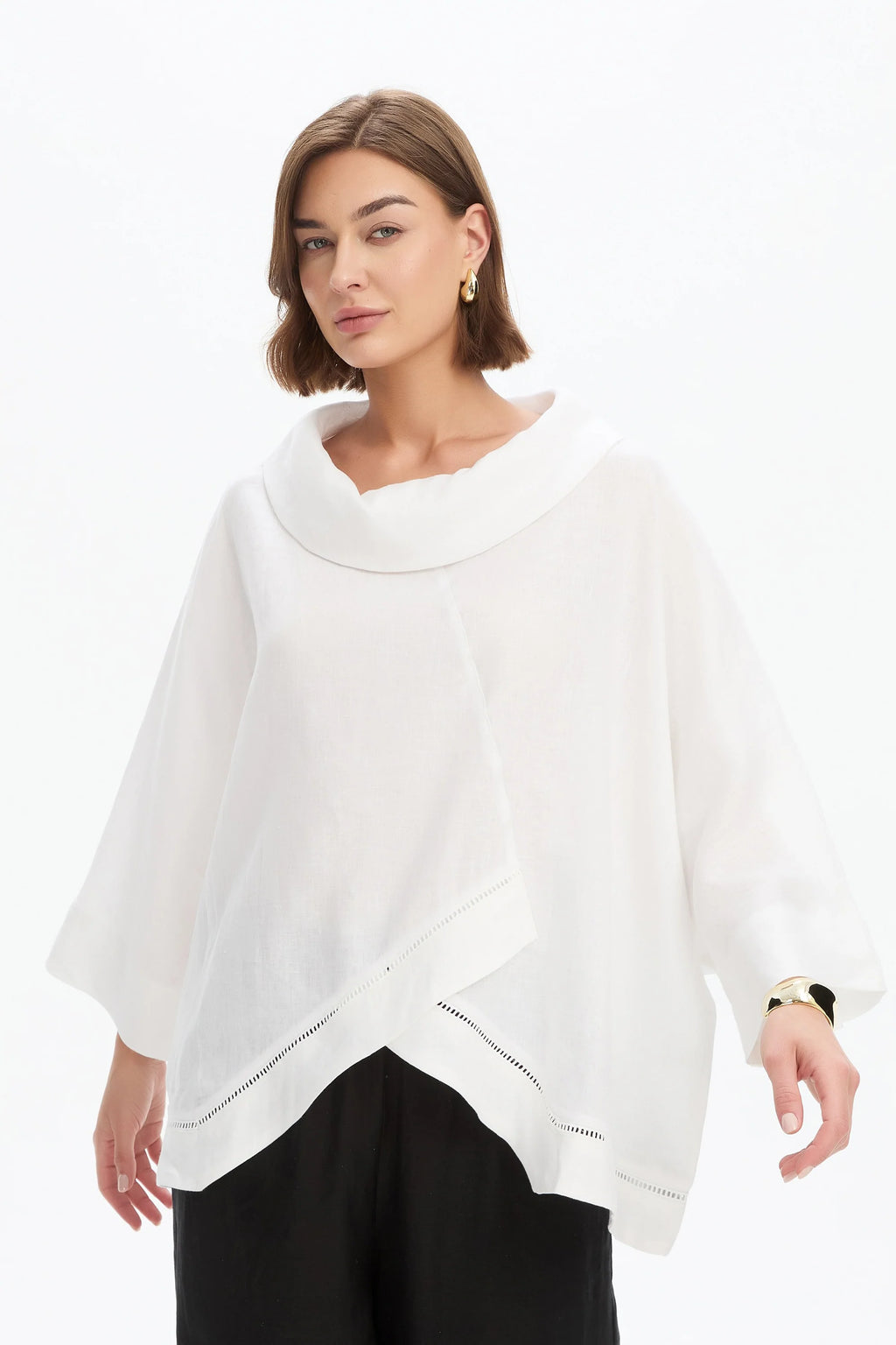 The Ladder Hem Cowl Neck Top brings a directional edge to everyday dressing with its considered, modern silhouette. Designed in a relaxed boxy fit, it features a soft cowl neckline and an asymmetric wrap front that creates subtle shape and movement.  By Tirelli